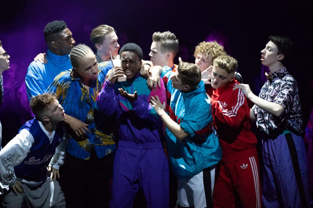 Performers College on stage in a group Performing.