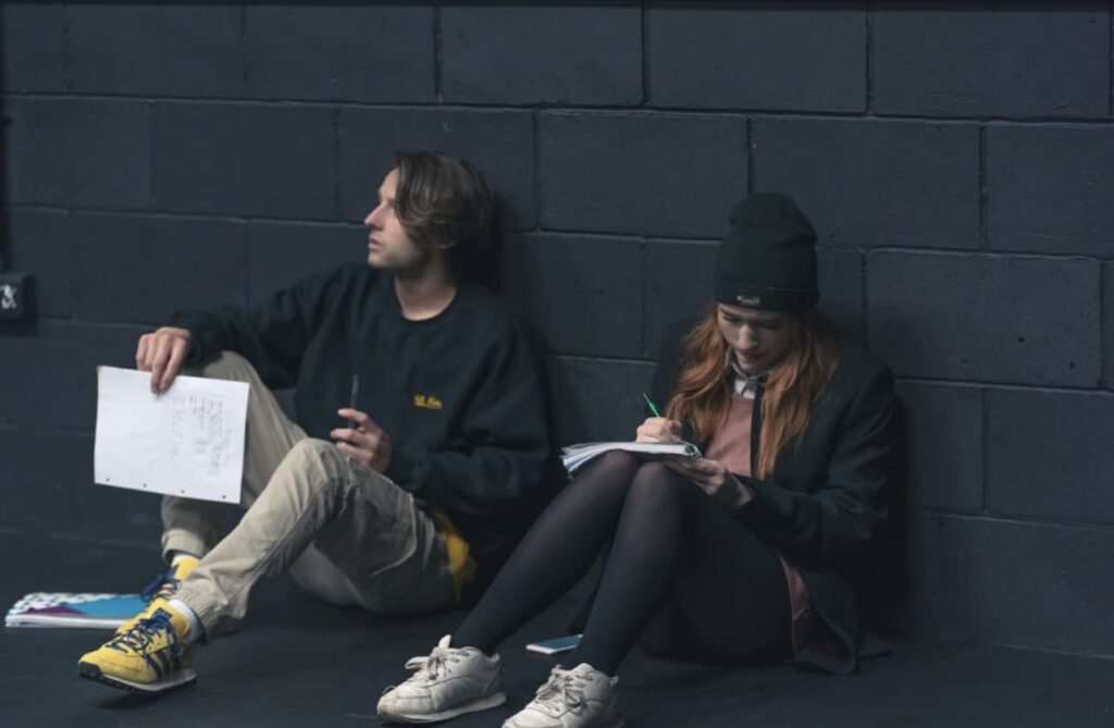 Two ICTheatre students sitting down