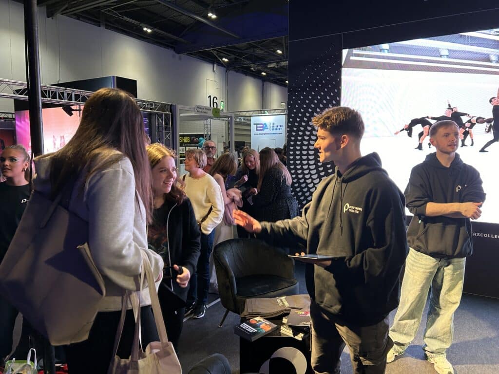 a performers college ambassador engaged in conversation with a Move It attendee