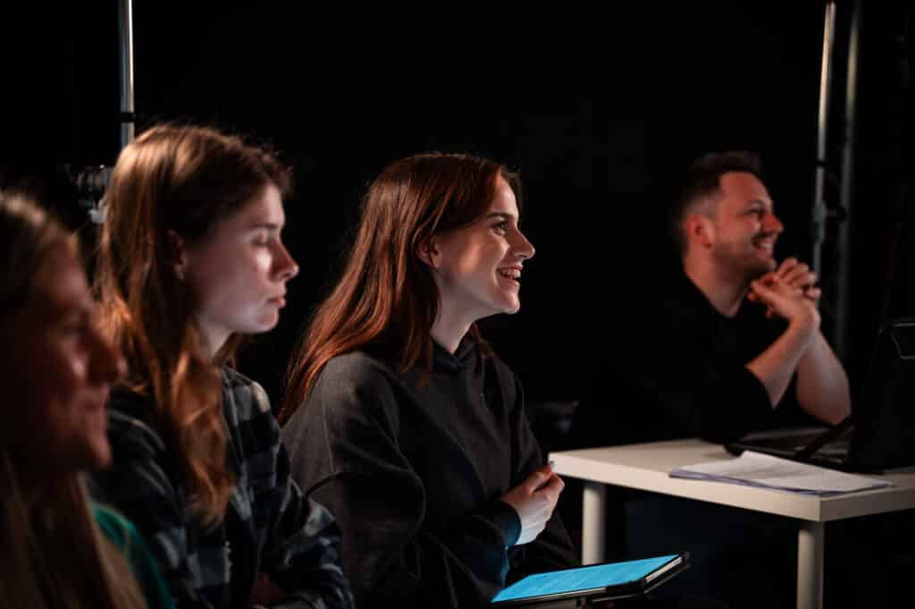 Emily smiles during an MA lecture
