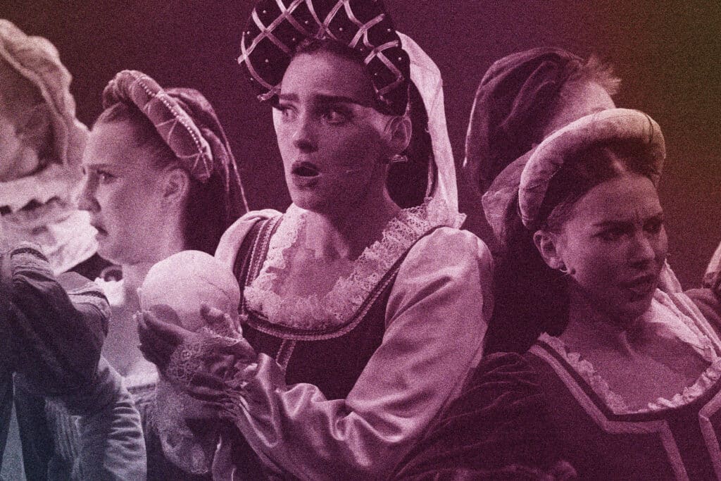 students perform in tudor costume, with the lead holding a skull