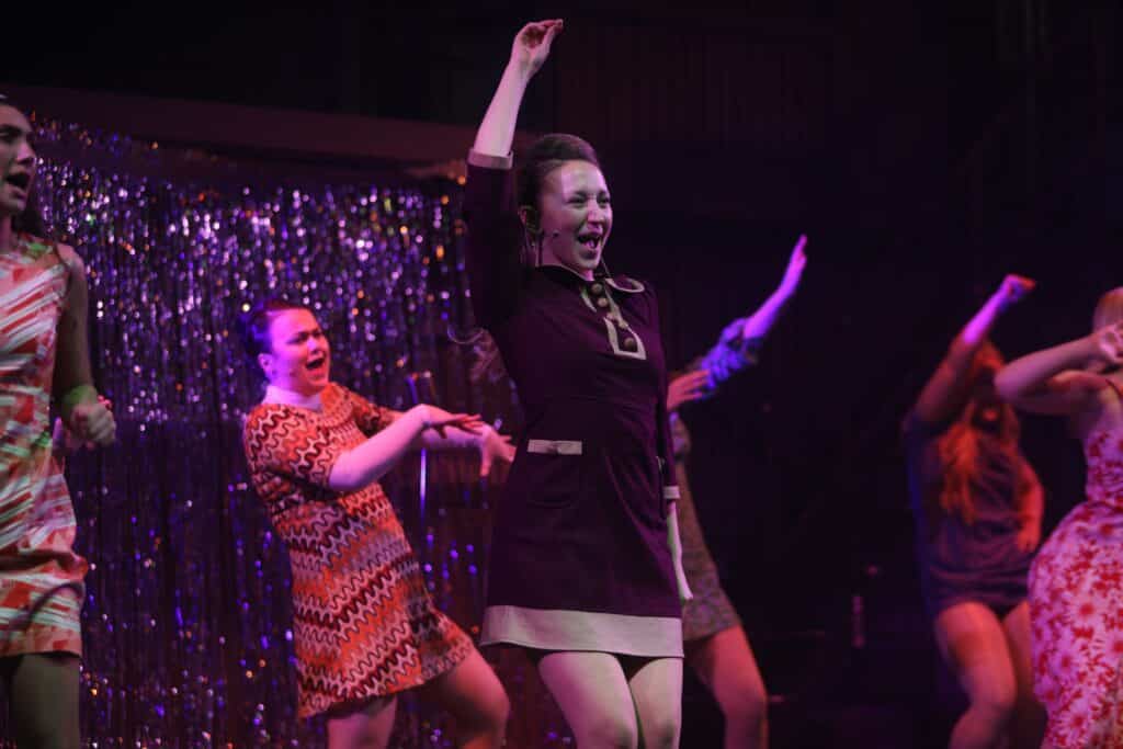 Performers College students on stage dancing and performing