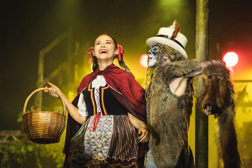 Two Performers College students performing Little Red Riding Hood on stage in costume