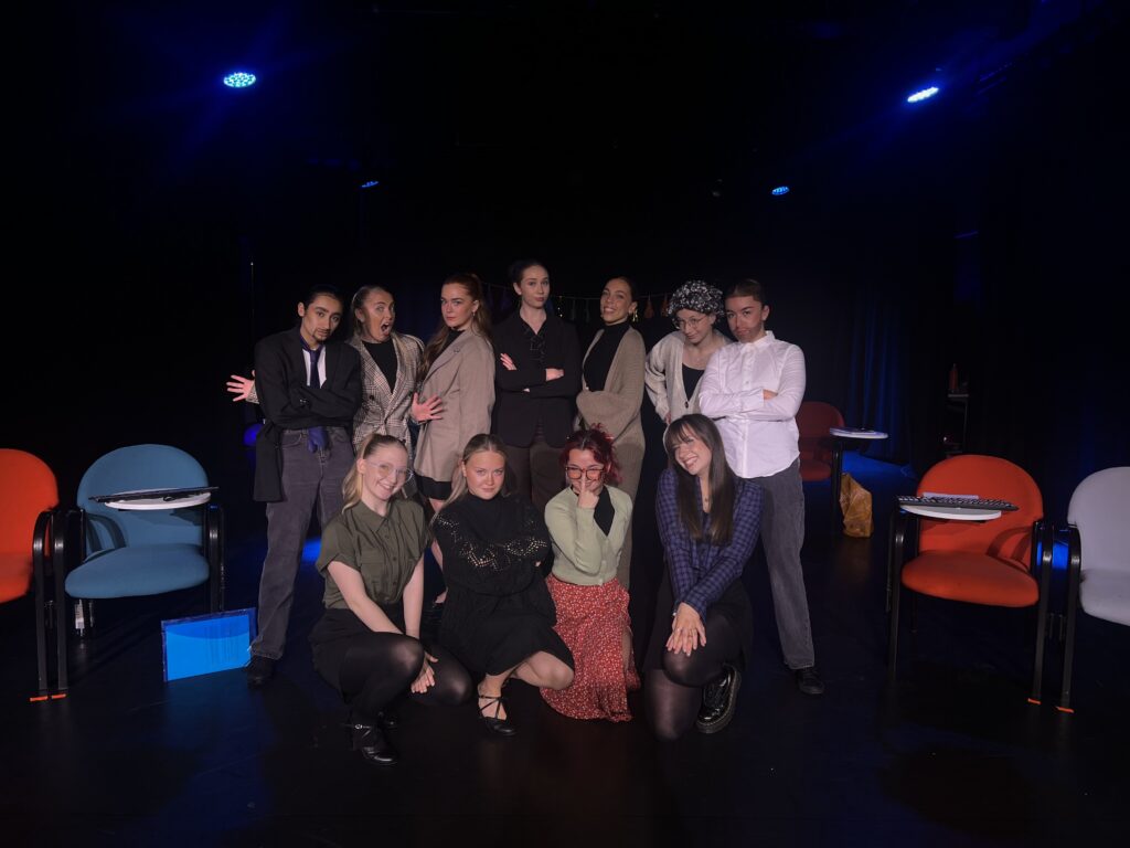 Billie poses with fellow students in class